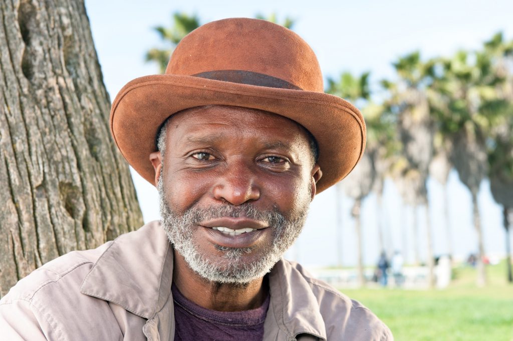 Elderly black man smiling - jesus is god fallacy