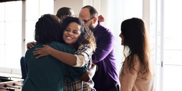 and the strangers shall be joined with them - Friends hugging each other
