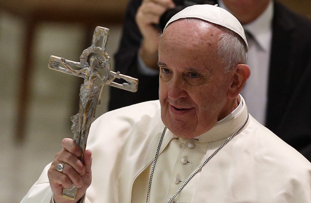 Pope Francis blesses with a crucifix