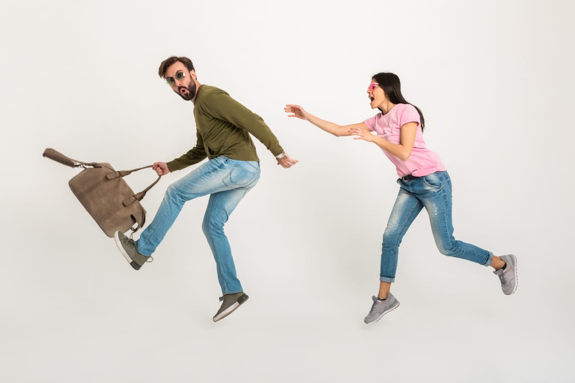 couple-woman-and-man-in-sweatshirt-fleeing