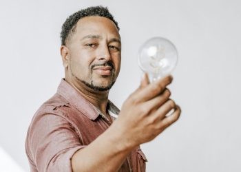 decode - man-holding-a-light-bulb