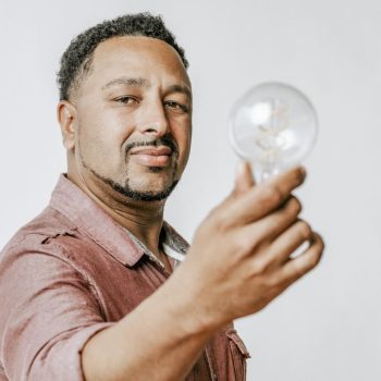 decode - man-holding-a-light-bulb