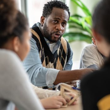 short teaching - african-teacher-explaining-and-teaching