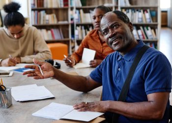 summa - mature-man-talking-to-teacher