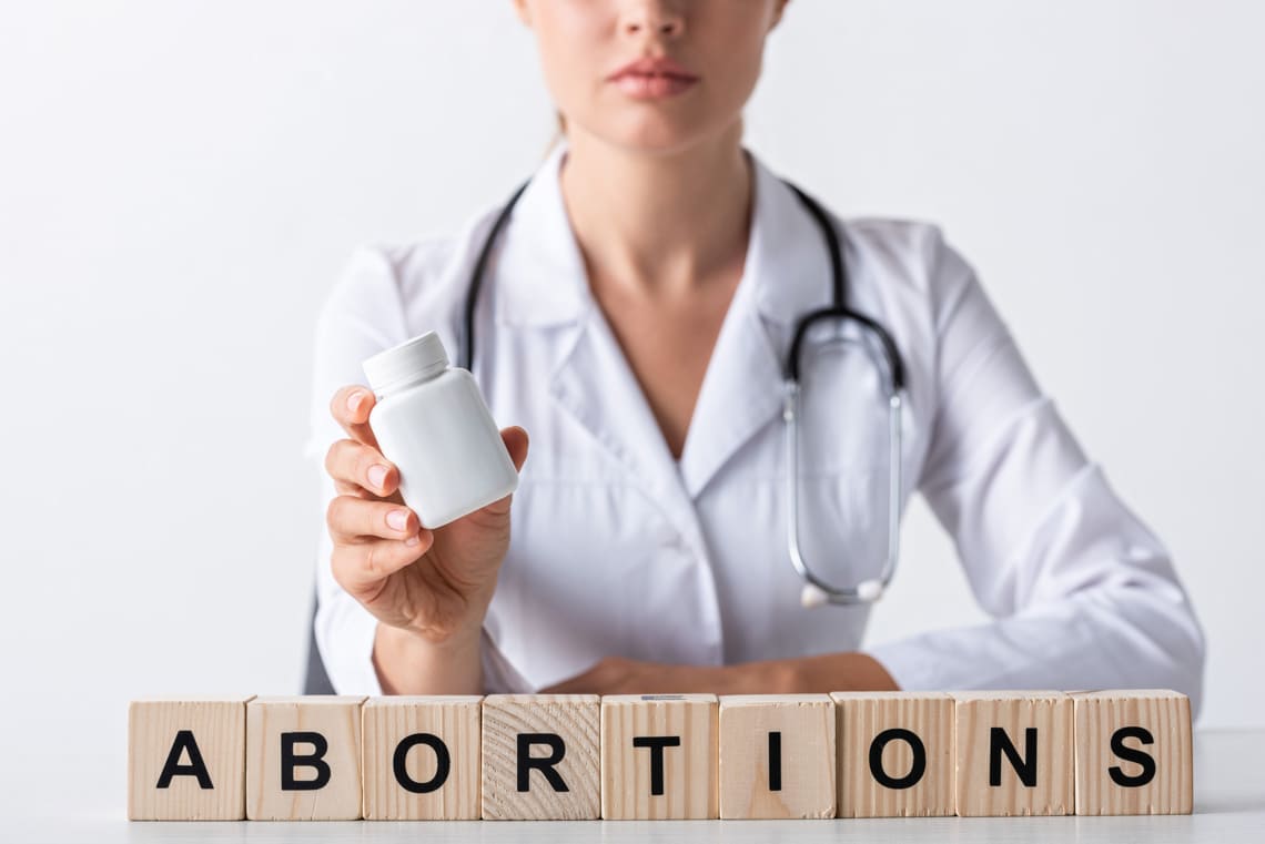 abortion-doctor-holding-bottle