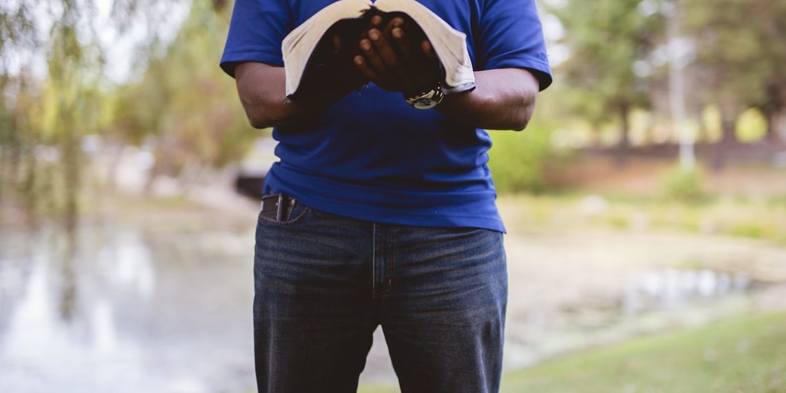 melchizedek and the manchild - male-standing-and-reading-bible